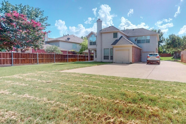 view of front of property featuring a garage and a front lawn