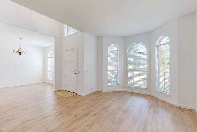 foyer entrance featuring light wood-type flooring and a wealth of natural light