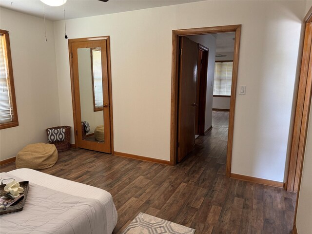 bedroom with dark wood-type flooring and ceiling fan