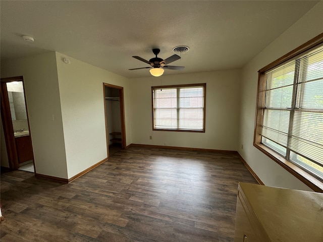 spare room featuring ceiling fan and dark hardwood / wood-style floors