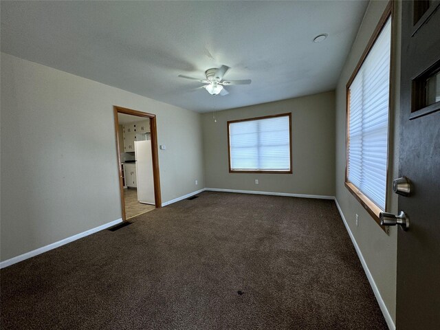 carpeted empty room with ceiling fan