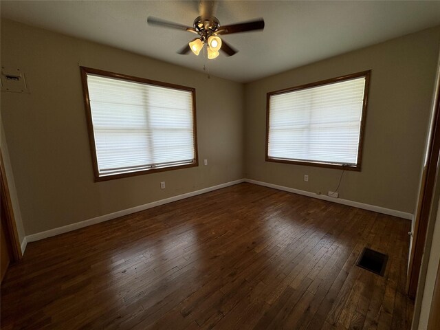 unfurnished room featuring ceiling fan and dark hardwood / wood-style floors