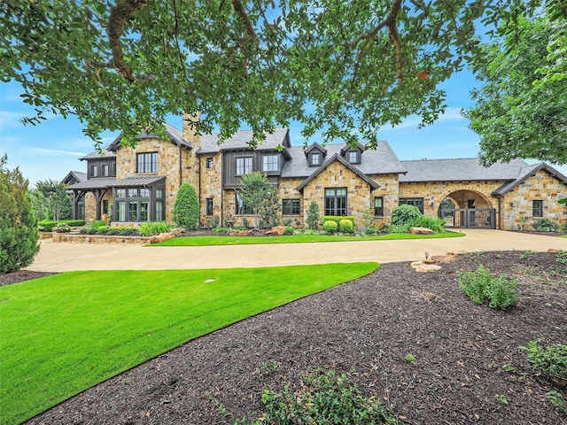 tudor home featuring a front yard