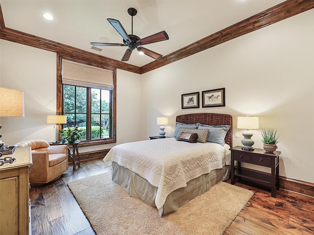 bedroom with ceiling fan, wood-type flooring, and crown molding