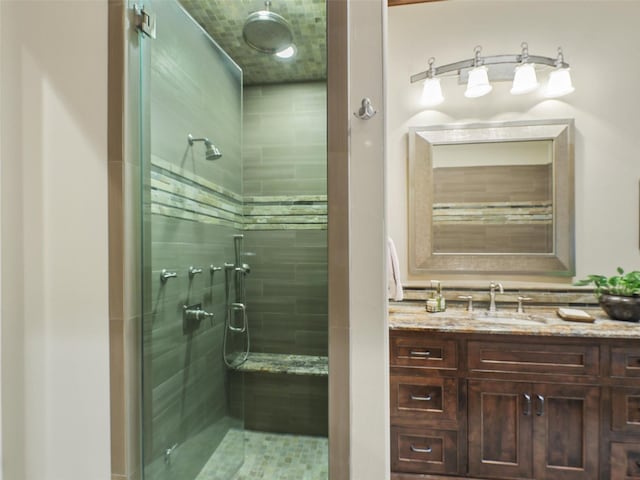 bathroom featuring vanity and a shower with shower door