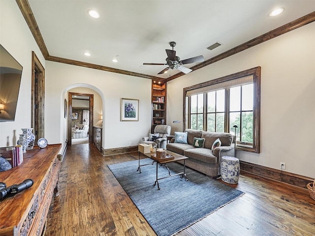 living room featuring ceiling fan, dark hardwood / wood-style floors, and ornamental molding