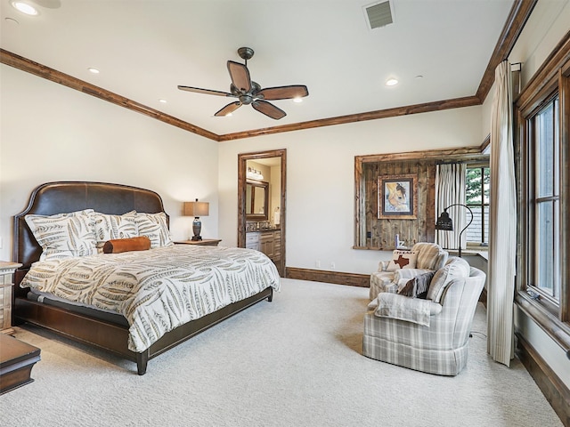 bedroom with ceiling fan, carpet floors, ornamental molding, and connected bathroom