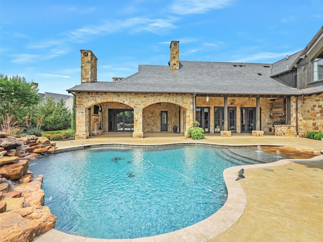 view of pool featuring pool water feature and a patio area