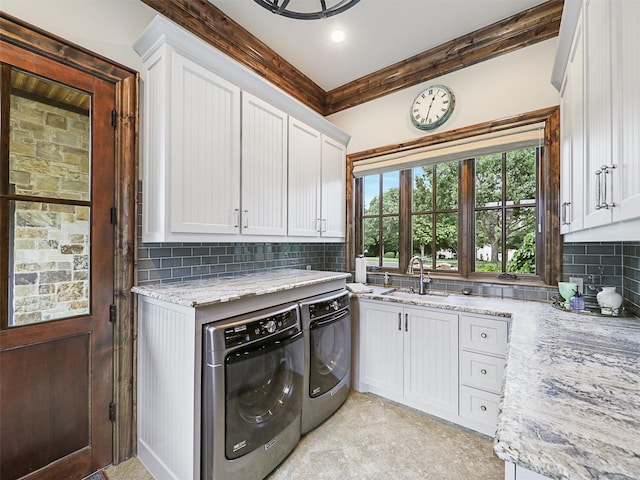 washroom with separate washer and dryer, sink, and cabinets