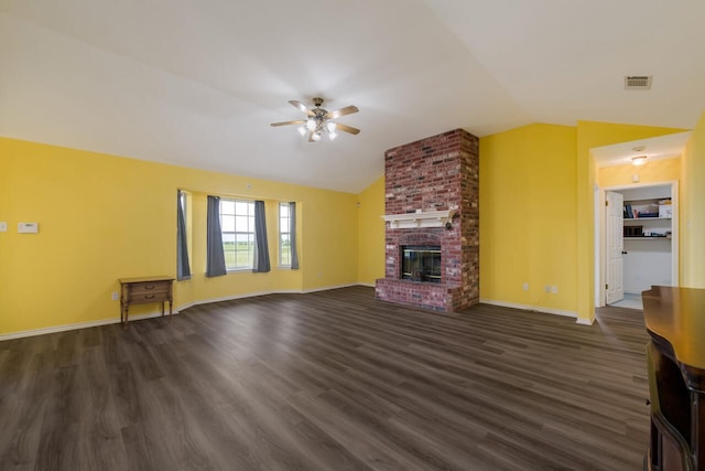 unfurnished living room with dark hardwood / wood-style floors, ceiling fan, a brick fireplace, brick wall, and lofted ceiling