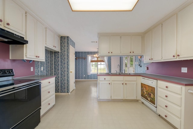 kitchen featuring dishwasher, light tile floors, sink, and black electric range