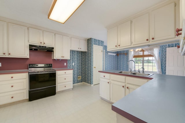 kitchen featuring sink, white cabinetry, black range with electric stovetop, and light tile floors