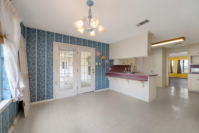 kitchen featuring tile floors, a kitchen breakfast bar, and a healthy amount of sunlight