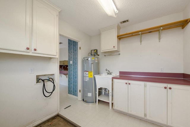 laundry area with a textured ceiling, washer hookup, sink, electric water heater, and light tile floors