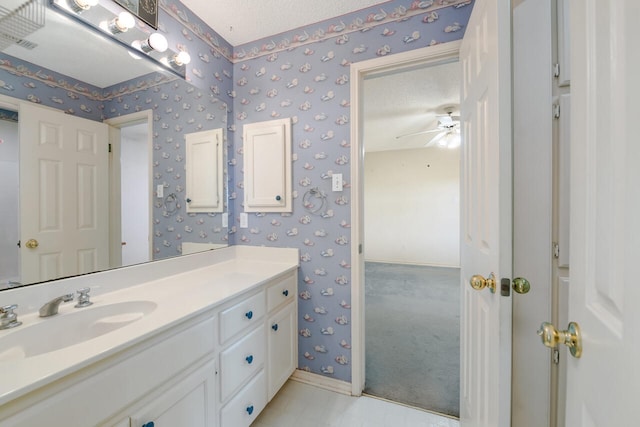 bathroom featuring a textured ceiling, oversized vanity, ceiling fan, and tile floors