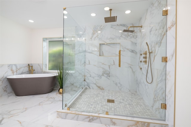 bathroom featuring plus walk in shower and tile walls