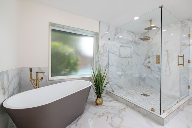 bathroom with tile walls and independent shower and bath