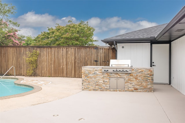 view of patio with an outdoor kitchen, a fenced in pool, and a grill