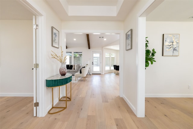 hallway featuring beamed ceiling, french doors, and light hardwood / wood-style flooring