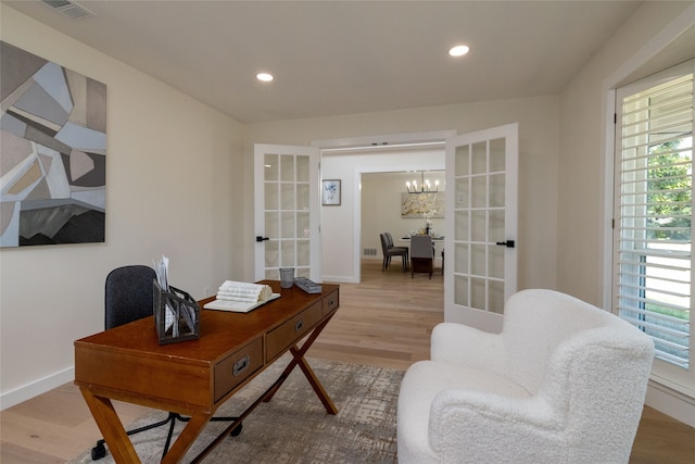 office space featuring a chandelier, wood-type flooring, and french doors