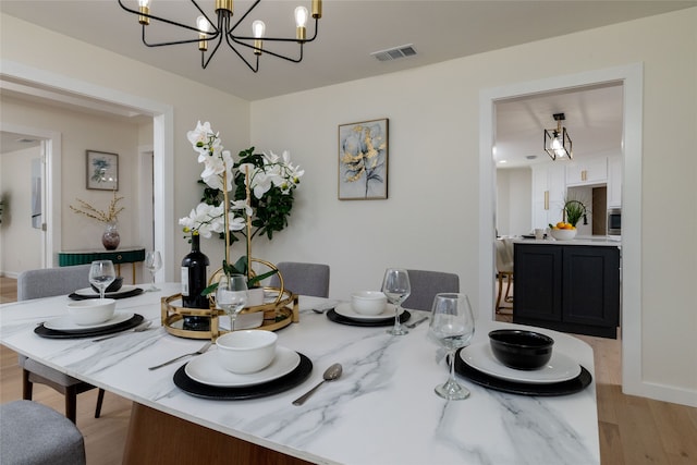 dining room featuring a chandelier and light wood-type flooring