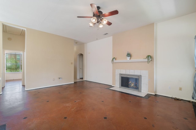 unfurnished living room with a tile fireplace and ceiling fan