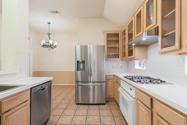 kitchen featuring appliances with stainless steel finishes, a chandelier, hanging light fixtures, lofted ceiling, and range hood