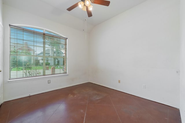 tiled empty room featuring plenty of natural light, ceiling fan, and vaulted ceiling