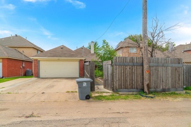 exterior space with cooling unit and a garage