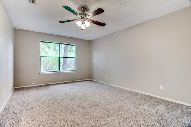 carpeted empty room featuring ceiling fan and a textured ceiling