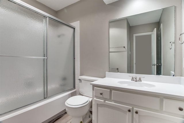 full bathroom with hardwood / wood-style floors, vanity, toilet, and bath / shower combo with glass door