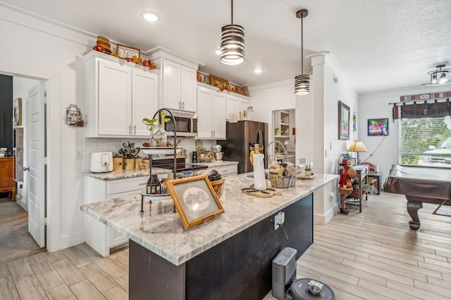 kitchen with white cabinetry, hanging light fixtures, a kitchen island, stainless steel appliances, and pool table