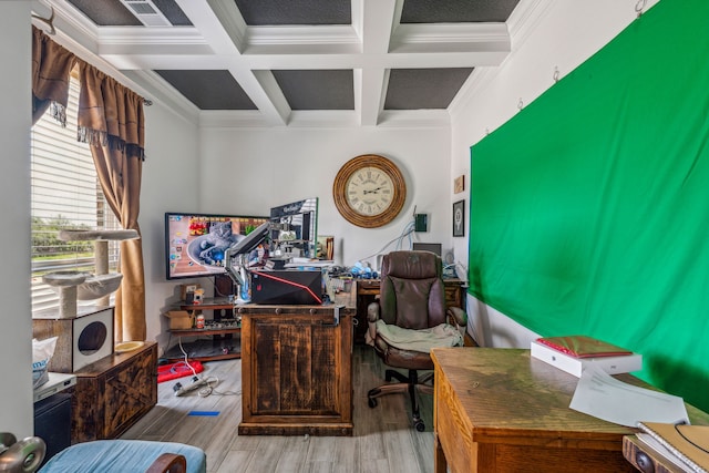 office space featuring beamed ceiling, hardwood / wood-style flooring, coffered ceiling, and ornamental molding