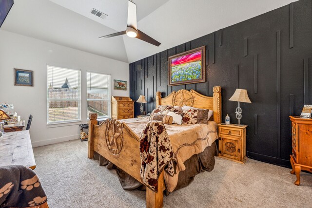 bedroom featuring light colored carpet, vaulted ceiling, and ceiling fan