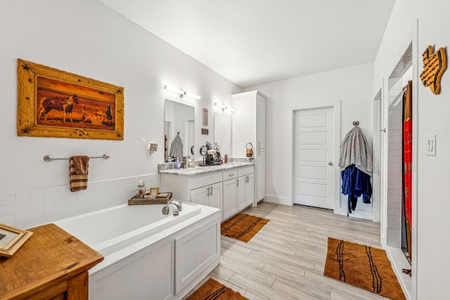 bathroom featuring separate shower and tub and vanity