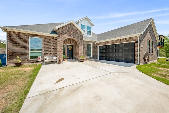 view of front of house with a garage and a front yard