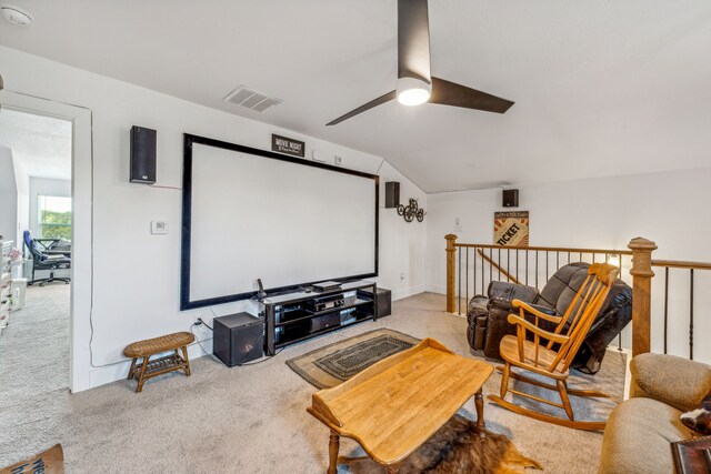 carpeted home theater room featuring ceiling fan and lofted ceiling