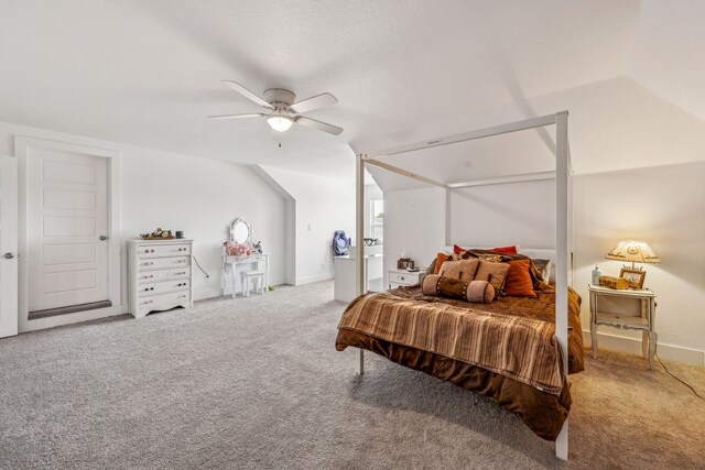 carpeted bedroom featuring vaulted ceiling and ceiling fan