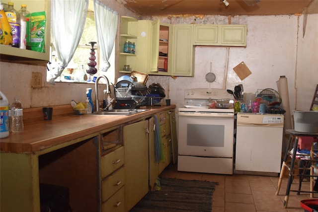 kitchen with light tile patterned flooring, sink, and white appliances