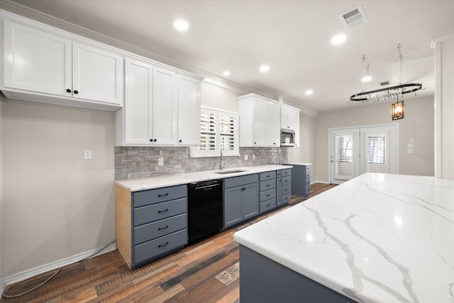 kitchen with backsplash, dishwasher, dark hardwood / wood-style floors, light stone counters, and white cabinets