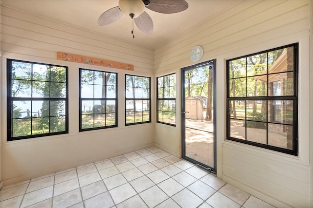 unfurnished sunroom featuring ceiling fan