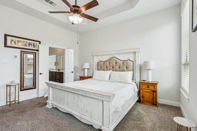 bedroom with carpet floors, ensuite bath, and ceiling fan