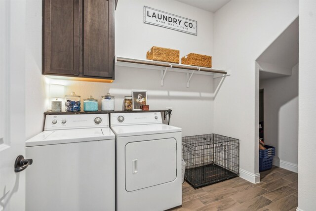 washroom with cabinets, dark hardwood / wood-style flooring, and independent washer and dryer