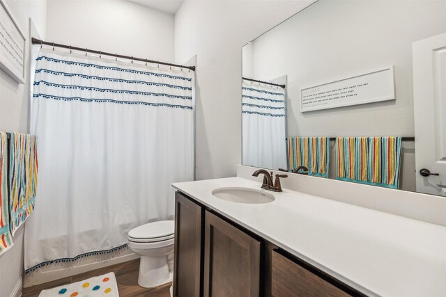 full bathroom with wood-type flooring, vanity, toilet, and shower / bath combo