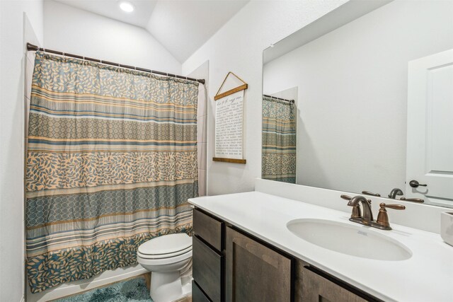 bathroom featuring lofted ceiling, vanity, and toilet