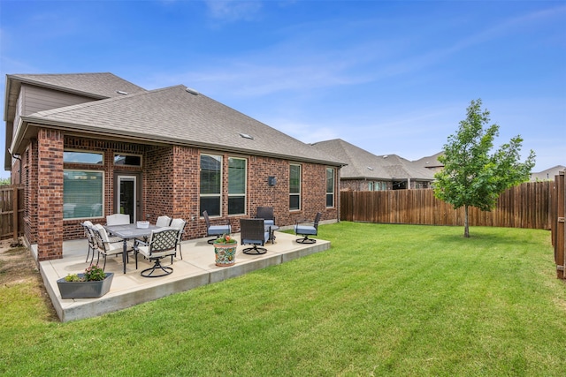 back of house featuring a lawn and a patio area