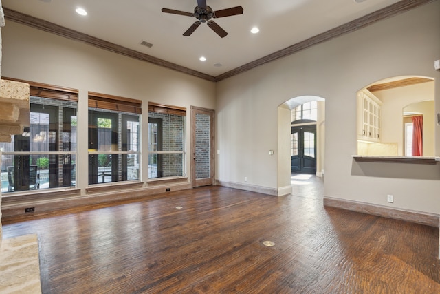 unfurnished living room featuring crown molding, ceiling fan, and dark wood-type flooring