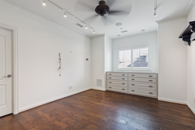 unfurnished bedroom featuring rail lighting, dark hardwood / wood-style floors, ceiling fan, and crown molding