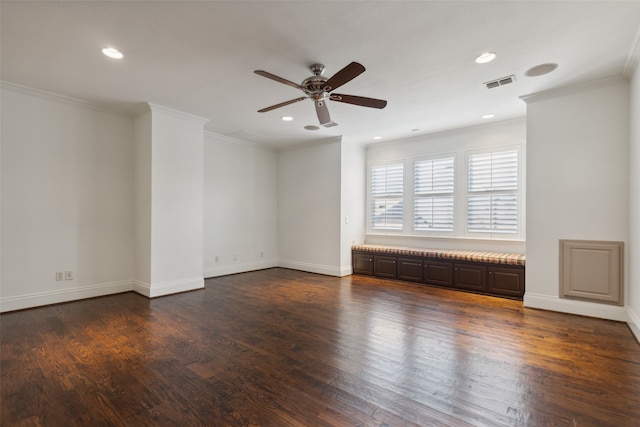 empty room with dark wood-type flooring, ceiling fan, and ornamental molding