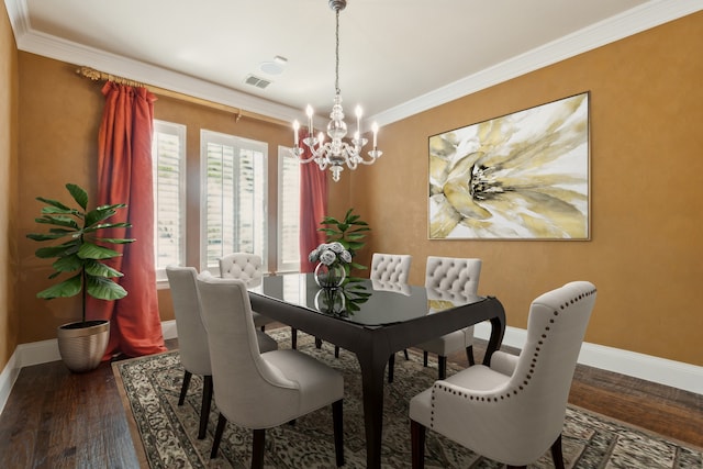 dining room featuring dark hardwood / wood-style floors, crown molding, and a chandelier